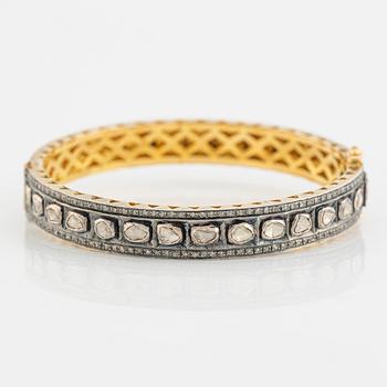 A faceted diamond bangle.