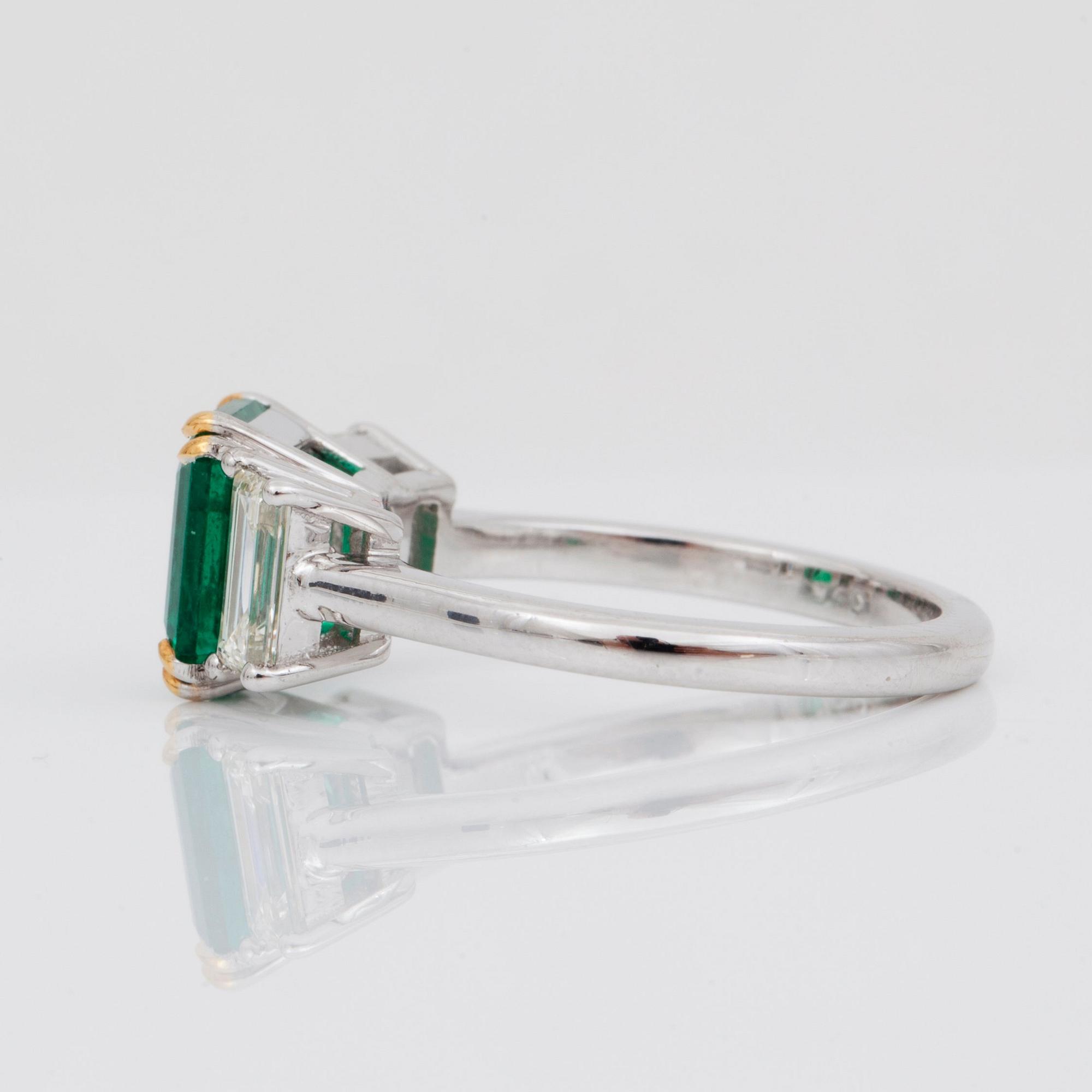 A 2.37 ct step-cut emerald and baguette-cut diamond ring. Total carat weight of diamonds circa 1.00 ct.