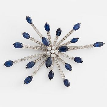 Brooch in 14K white gold with round brilliant, baguette, and navette-cut diamonds and navette-shaped sapphires.