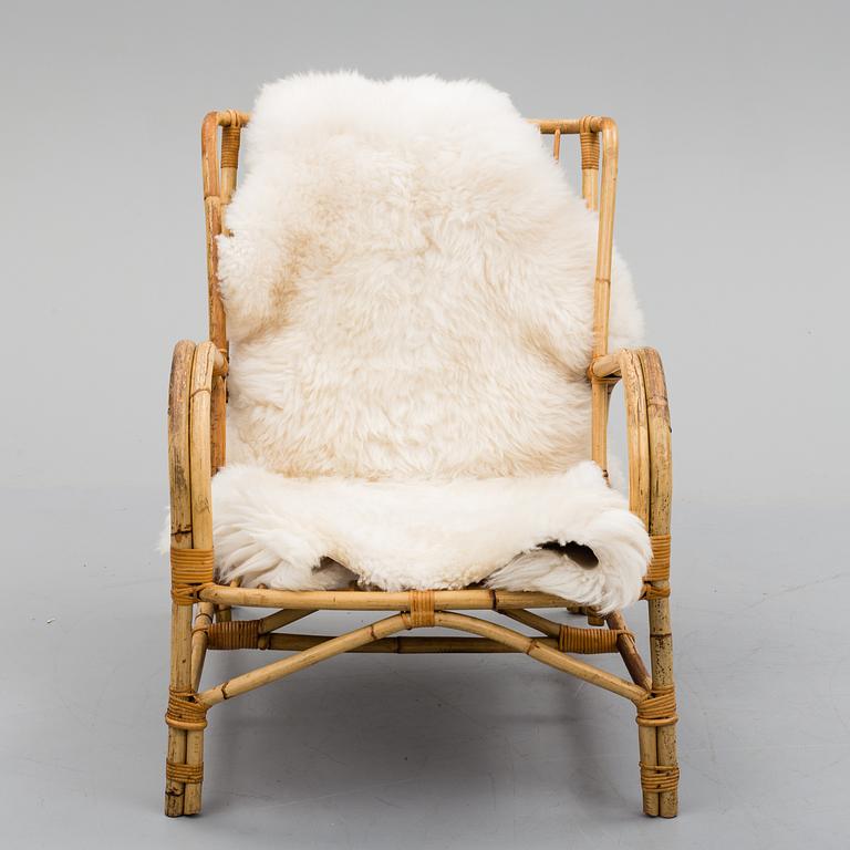 a mid 20th century rattan easy chair.