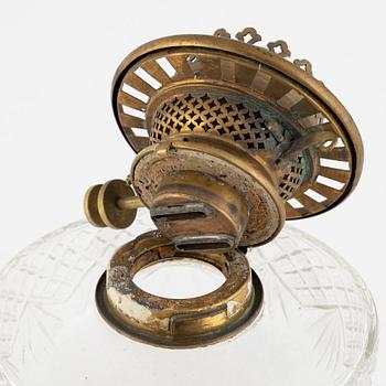 A brass and glass column shaped paraffin lamp, end of the 19th Century.