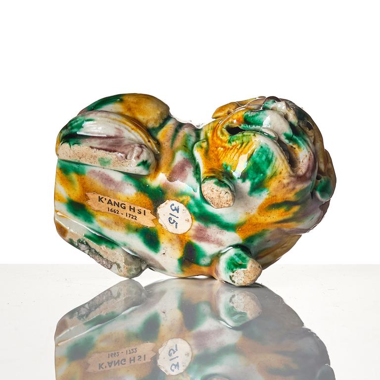 An 'egg and spinach' glazed figure of a mythical beast, Qing dynasty, Kangxi (1662-1722).