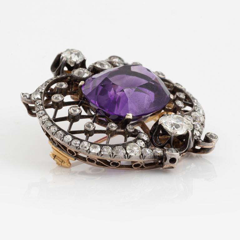 A brooch set with an amethyst and old-cut diamonds.