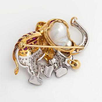 An 18K gold/ white gold elephant brooch with brilliant-cut diamonds, rubies, emerald, and cultured baroque pearl.