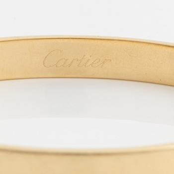 A Cartier "Anniversary Bracelet" in 18K gold set with a round brilliant-cut diamond.