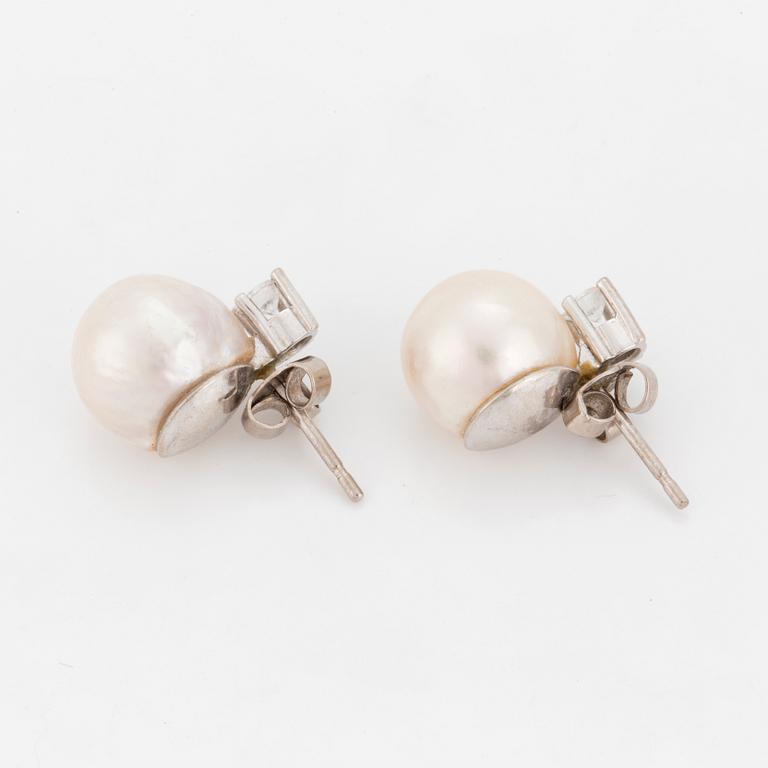 A pair of earrings set with cultured pearls and round, brilliant-cut diamonds.