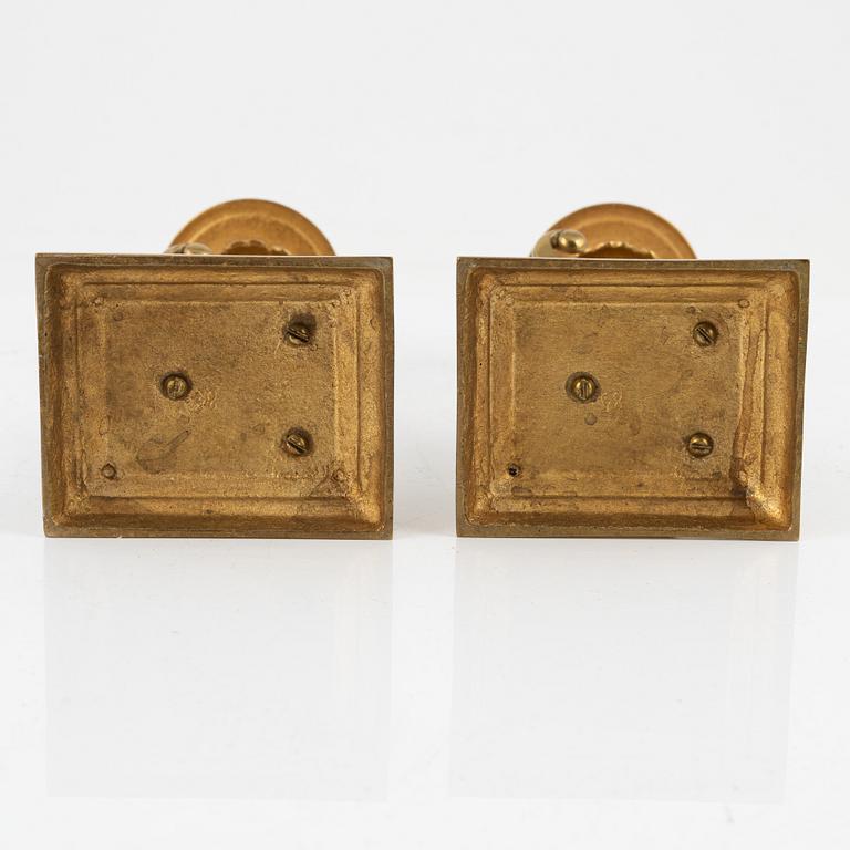 A pair of brass candleholders, 20th century.
