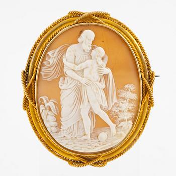 A brooch with a large shell cameo.