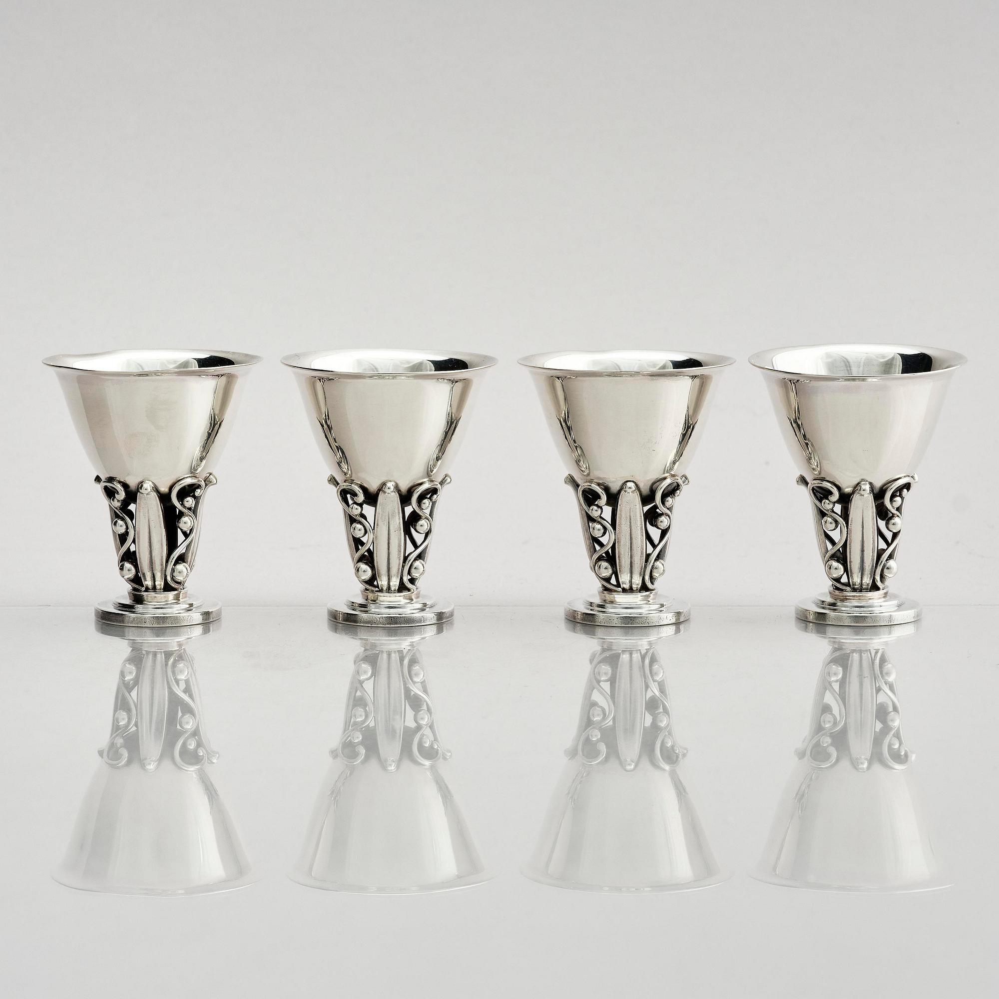 Evald Nielsen, four sterling silver beakers/cups on a foot, Denmark 20th century.