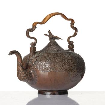 A German Rococo repoussé copper teapot, mid 18th century.