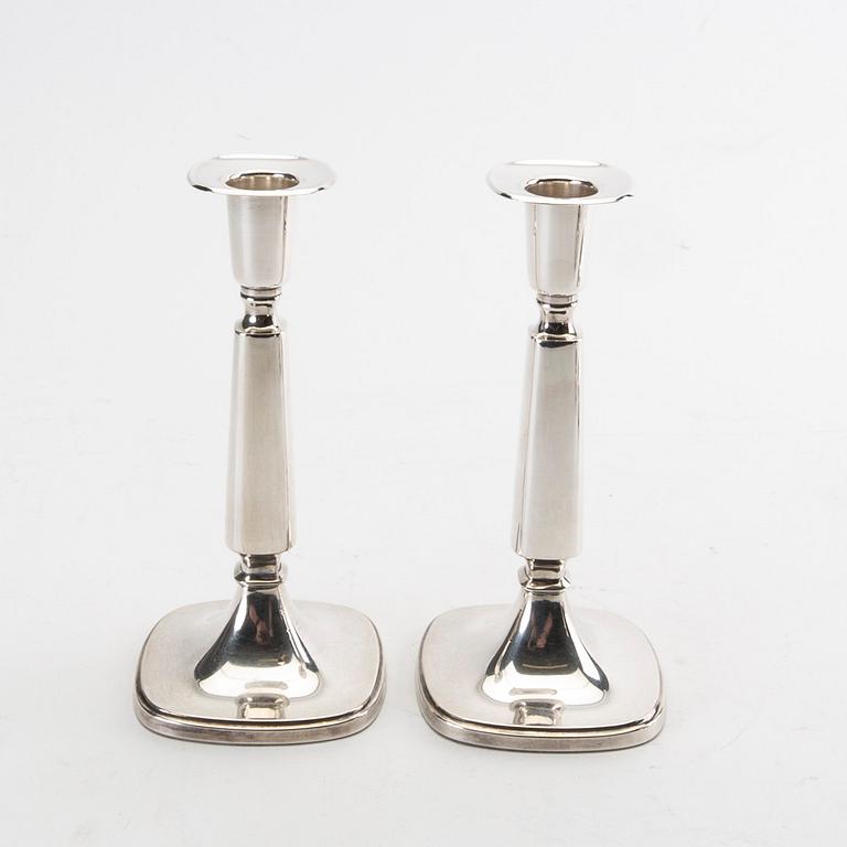 Two pairs of silver candle sticks from 1956 and 1992.