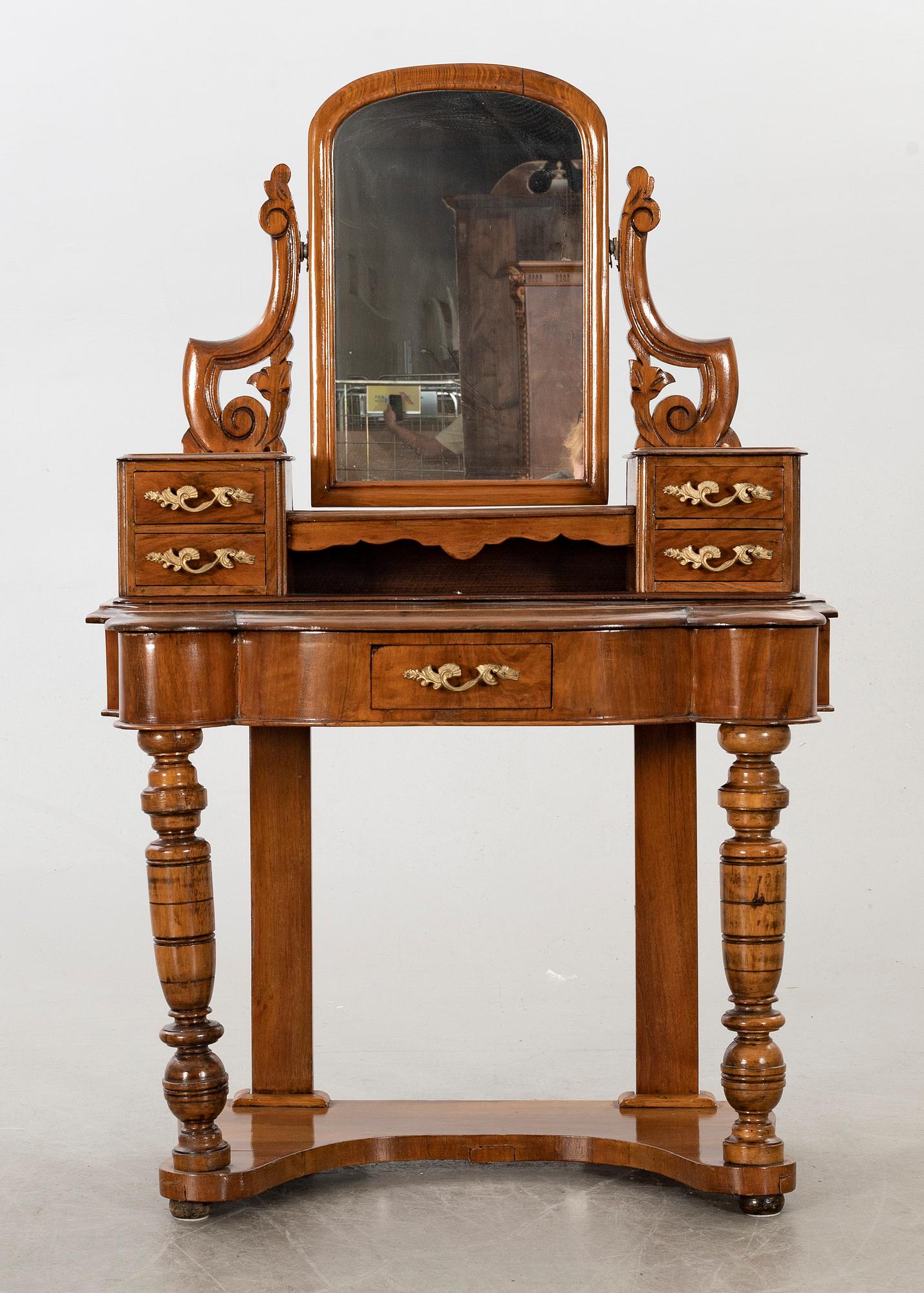 A second half of the 19th century table with mirror and a stool.
