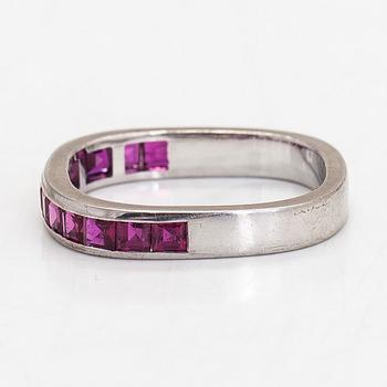 An 18K white gold eternity ring, with square-cut rubies.