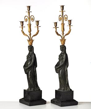 A pair of French Empire early 19th century three-light candelabra.