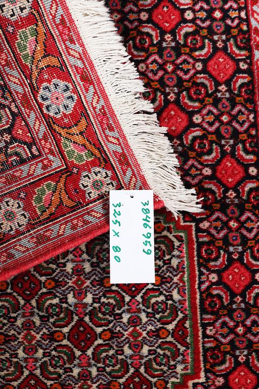A Runner carpet, Senneh, c. 325 x 80 cm.