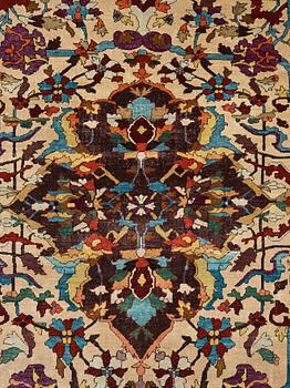 A RUG. An antique silk Kashan so called Motachem. 202,5 x 136,5 cm.