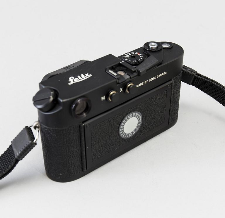 a black body Leica M4-P camera with no 1605951 made by Leitz Canada in 1982. With two lenses and a Leica Meter.