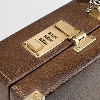 GUCCI, a brown leather briefcase.