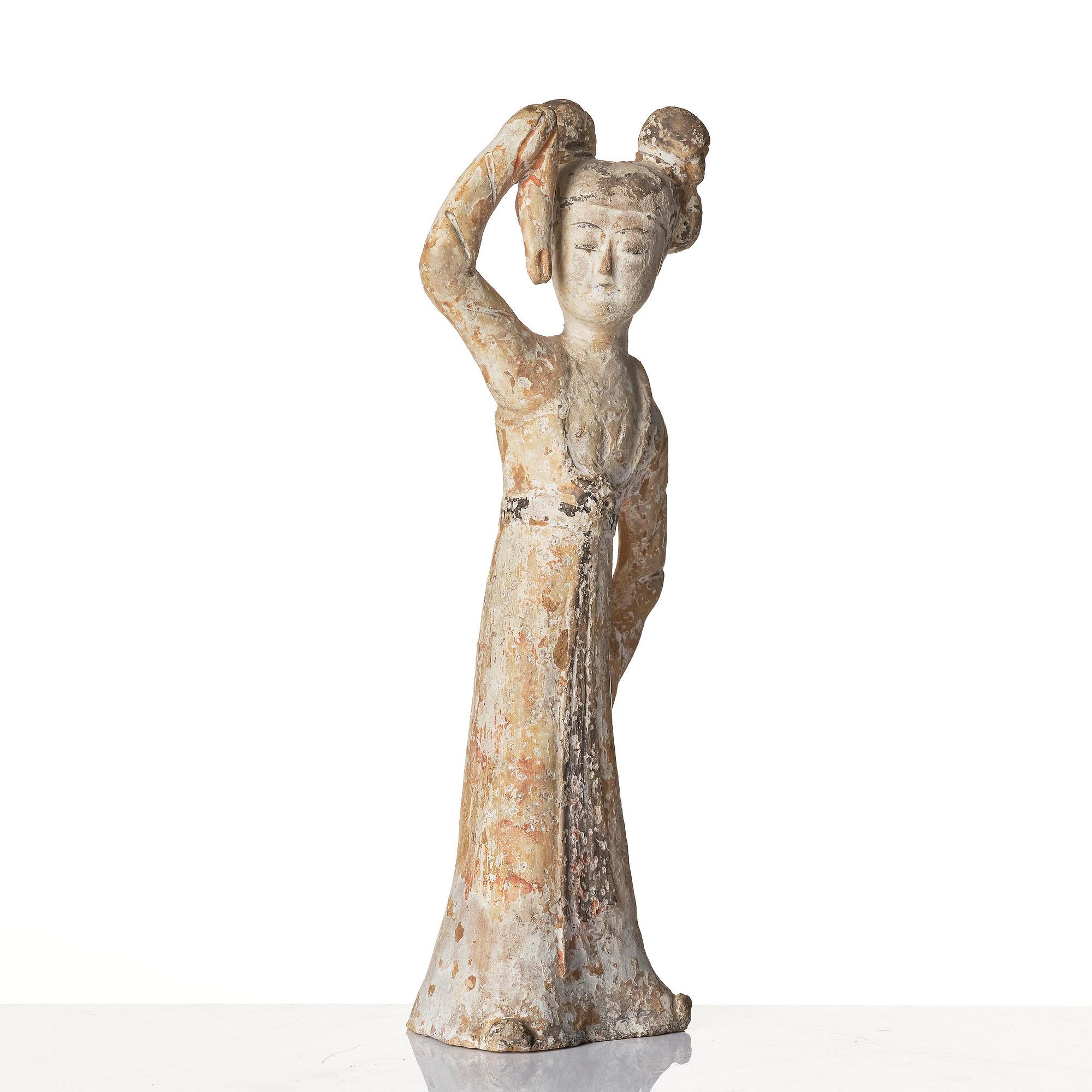 A painted pottery figure of a female dancer, Tang dynasty (608-906).