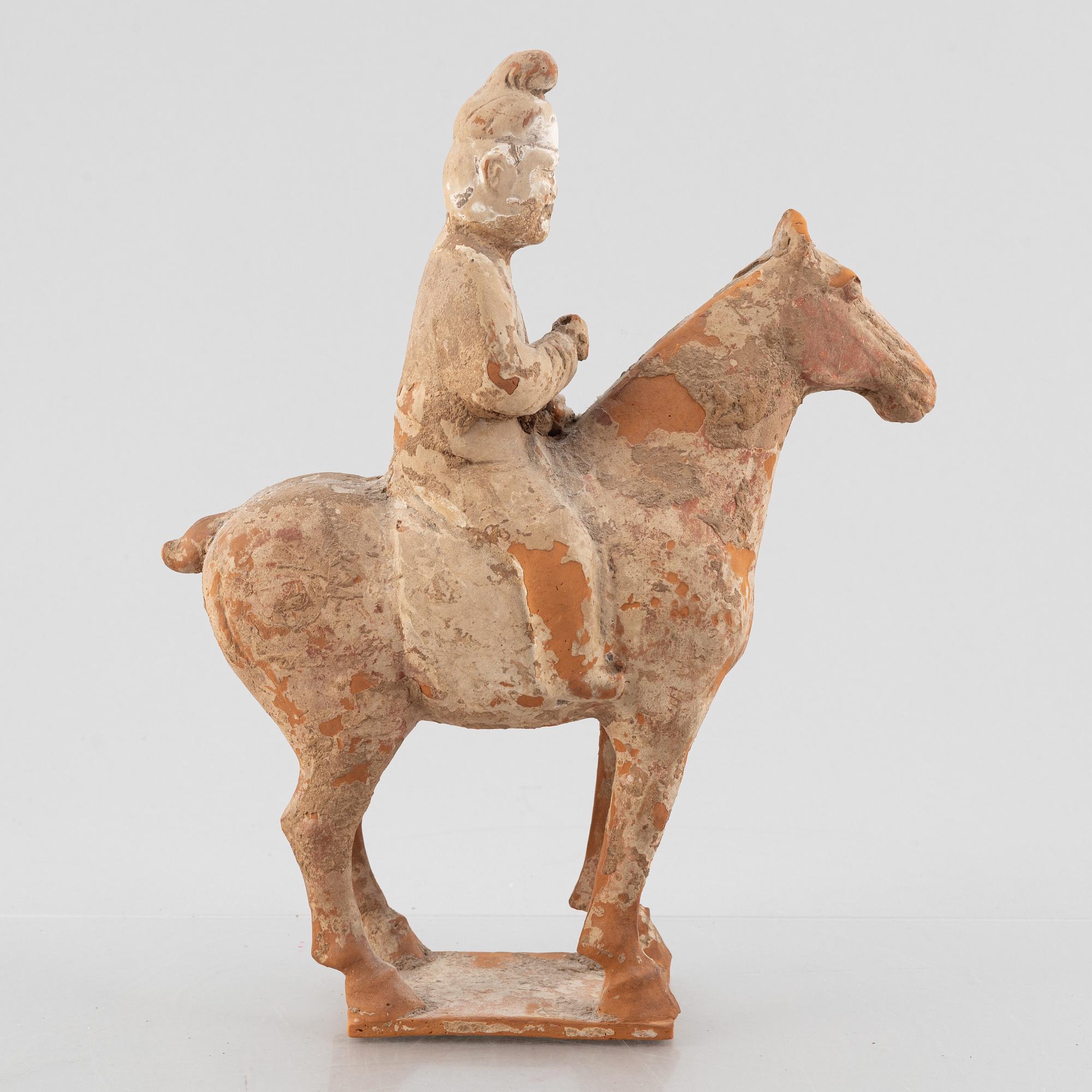 A painted pottery figure of an equestrian standard-bearer, Tang dynasty (618-907 AD.).