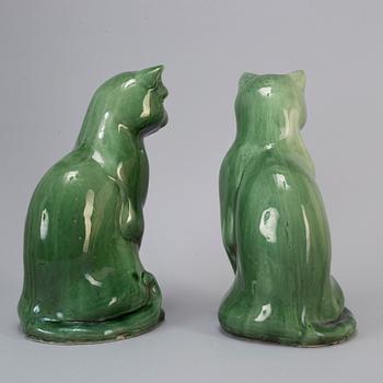 A pair of Chinese green glazed ceramic figurines of cats, 20th century.