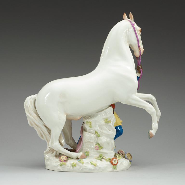 A large Meissen figure of a white horse and his groom, 20th Century.