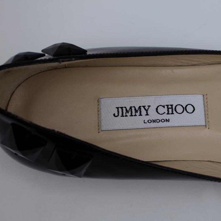 JIMMY CHOO, a pair of black ballerina shoes.