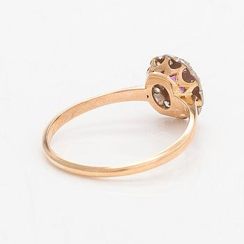 A 14K gold ring, with a pink sapphire and diamonds.