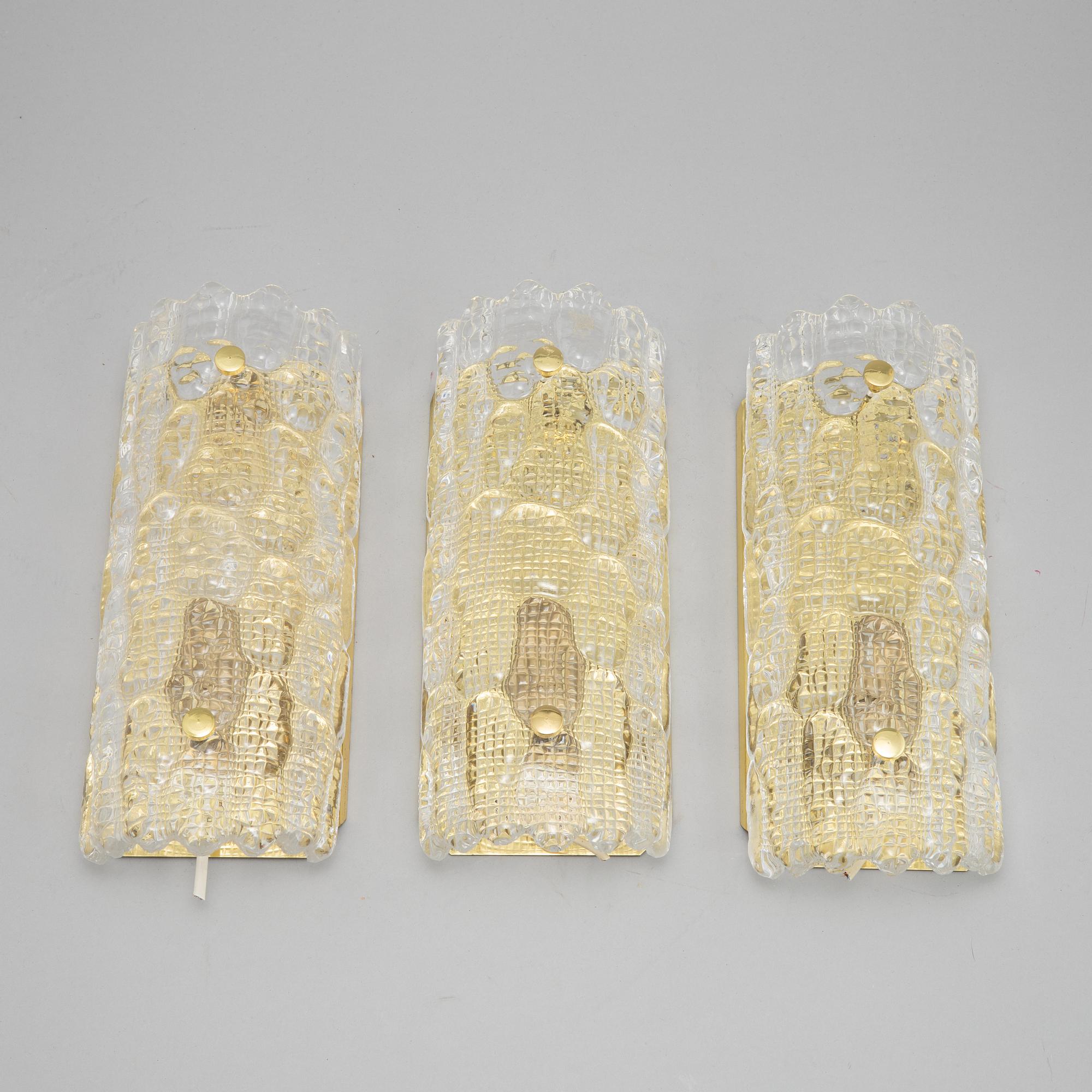 Carl Fagerlund, a set of three glass and brass wall lights, Orrefors/Nya ÖIA, second half of the 20th Century.