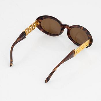 Gianni Versace, a pair of brown and gold sunglasses.