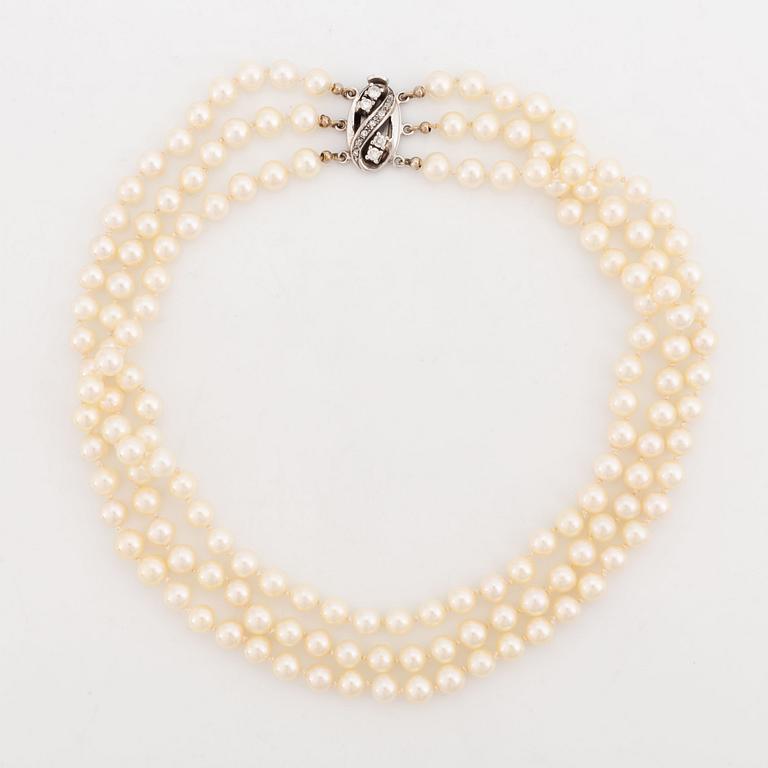 Three strand cultured pearl necklace, clasp with diamonds.