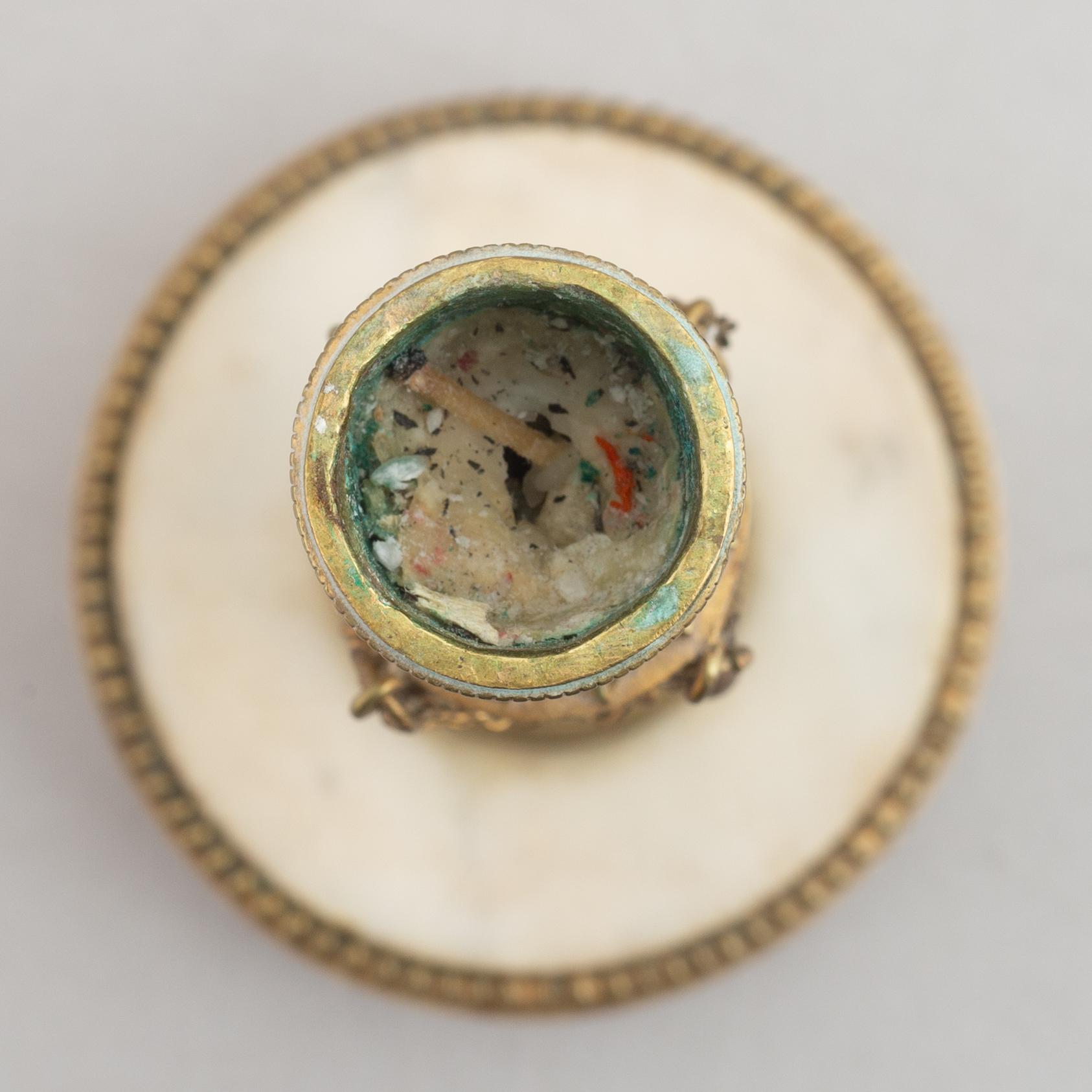 A late Gustavian gilt brass and marble candlestick, late 18th century.