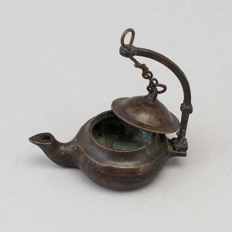 An 18th century bronze oil lamp.