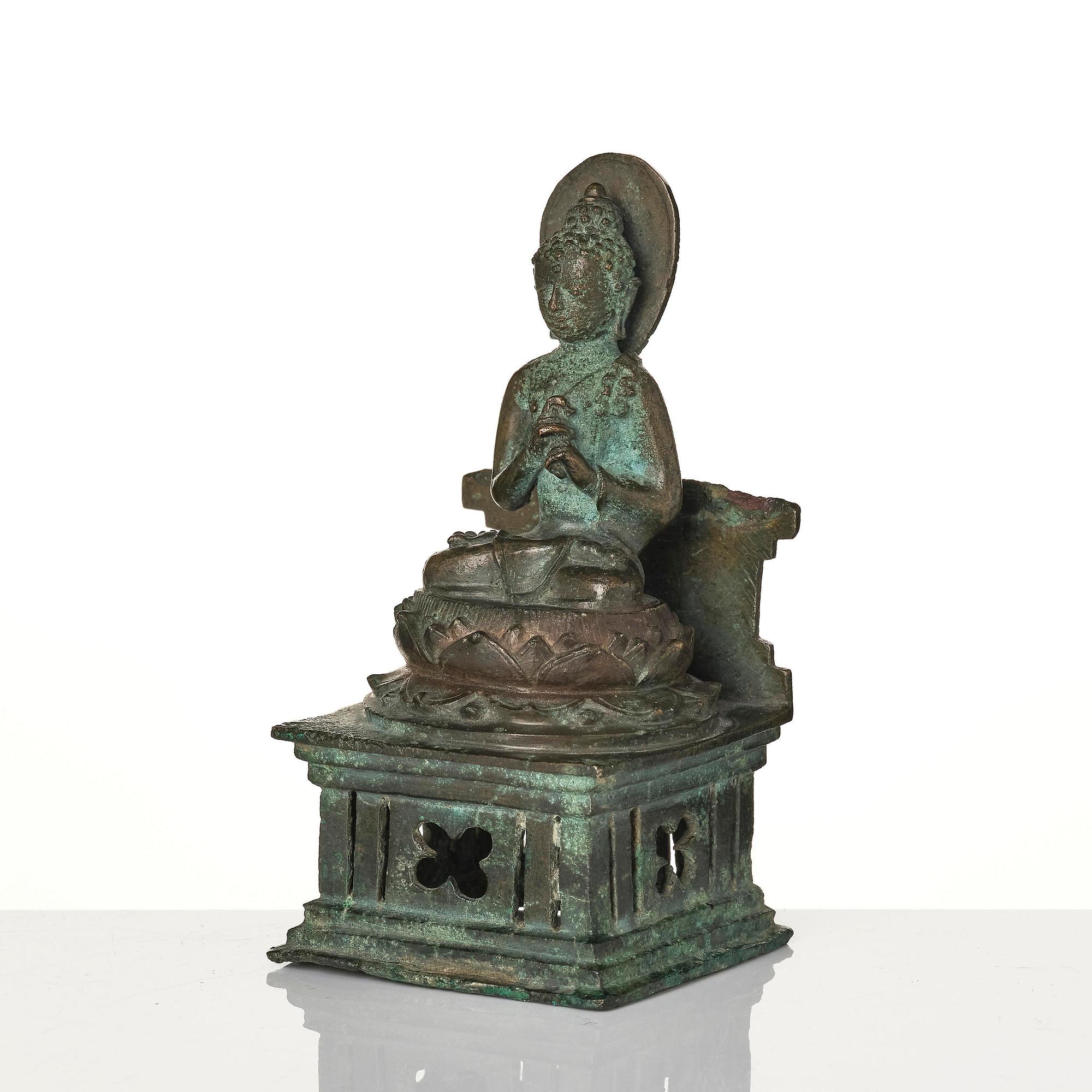 A bronze Buddha Vairocana, Eastern Java, 10th century.