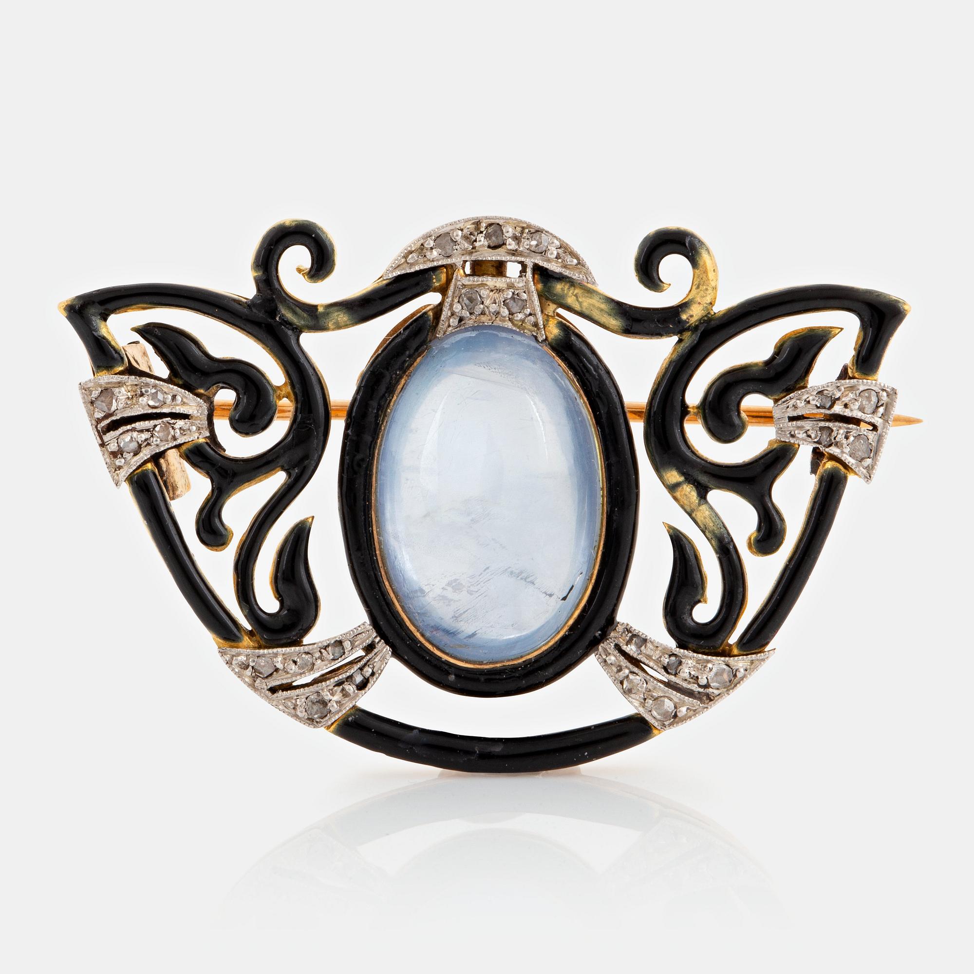 An 18K gold and platinum brooch set with a sapphire and rose-cut diamonds.