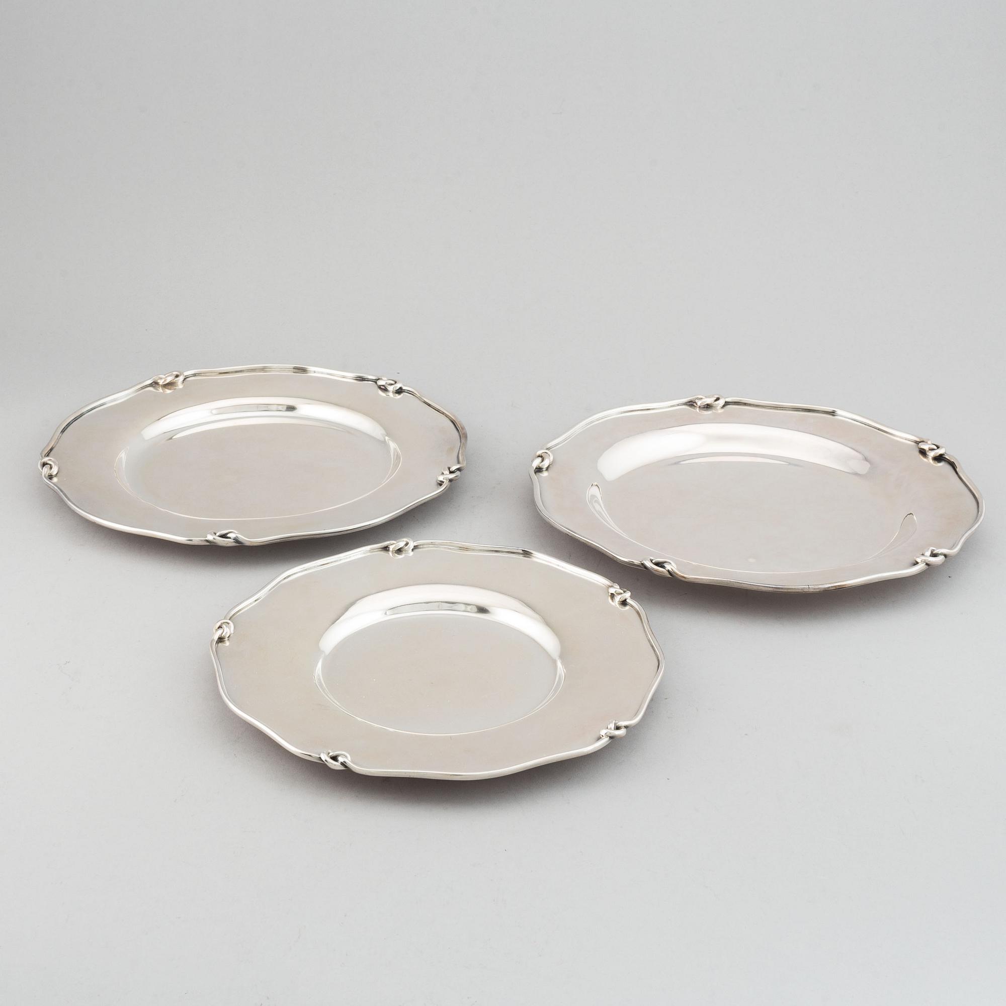 Three silver serving plates, decorated with "knots", Swedish import marks.