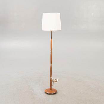 A 1960s brass and teak floor lamp.