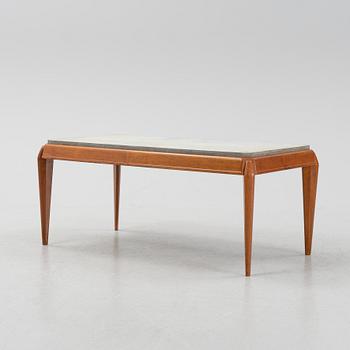 A mid 20th Century coffee table with a stone top.