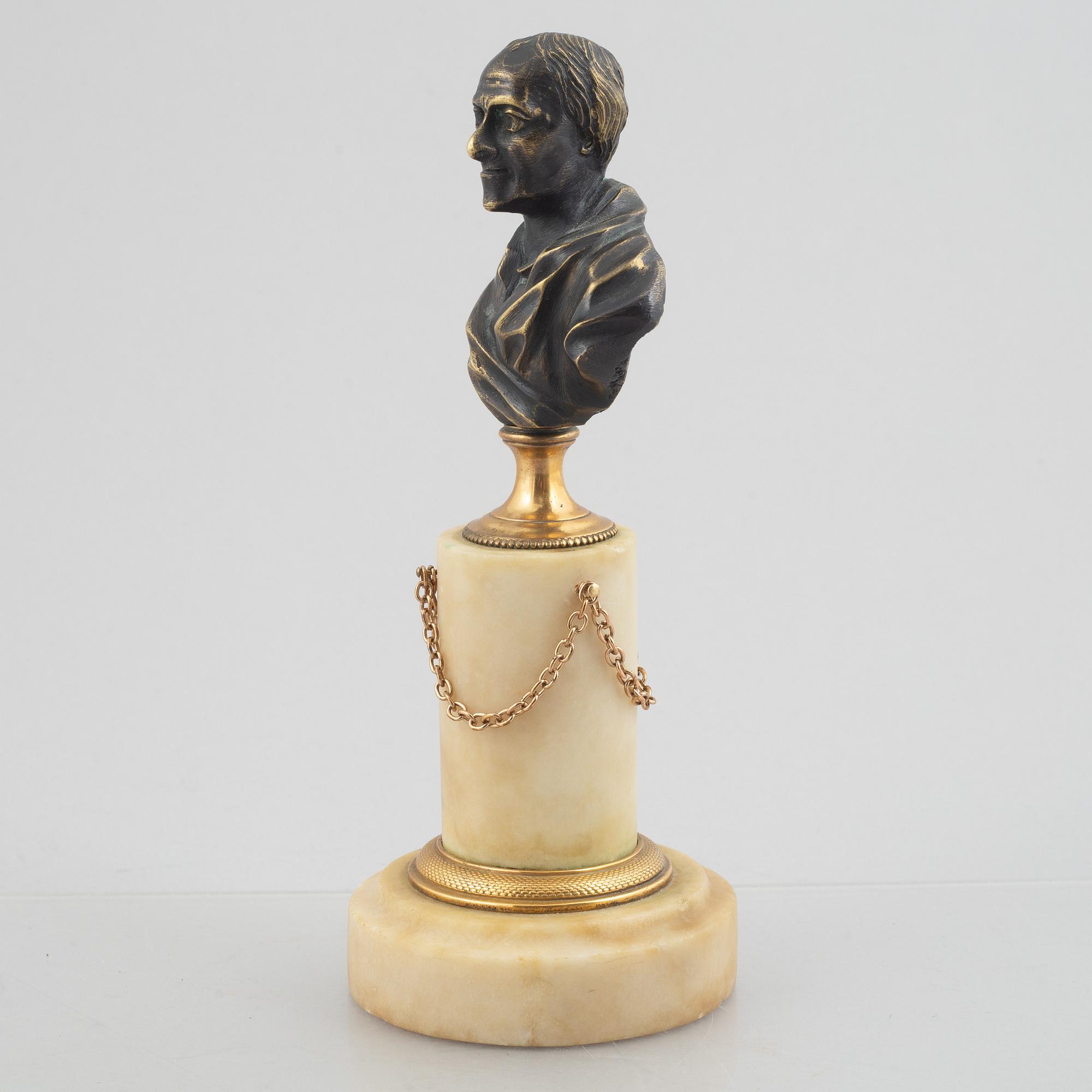 A Louis XVI patinated bronze and marble library bust of Voltaire, late 18th century.
