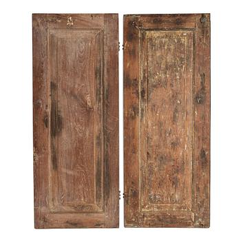 A pair of South East Asian carved wooden doors, presumably Java, 19th Century.