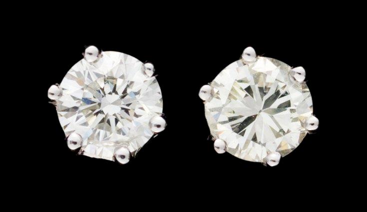 A pair of stud diamond earrings.
