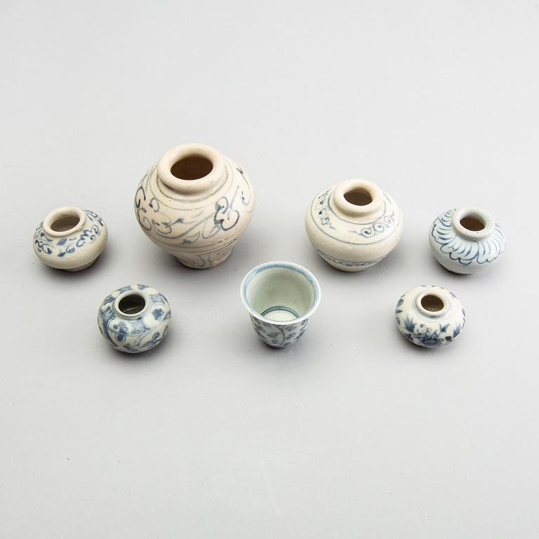 A group of six blue and white South East Asian jars and a cup, 17th/18th Century.