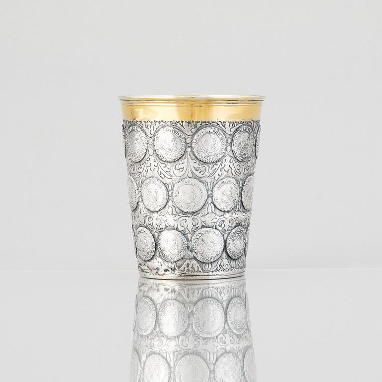 A German 18th century parcel-gilt silver coin-beaker, Frankfurt an der Oder, makers mark possibly ICST.