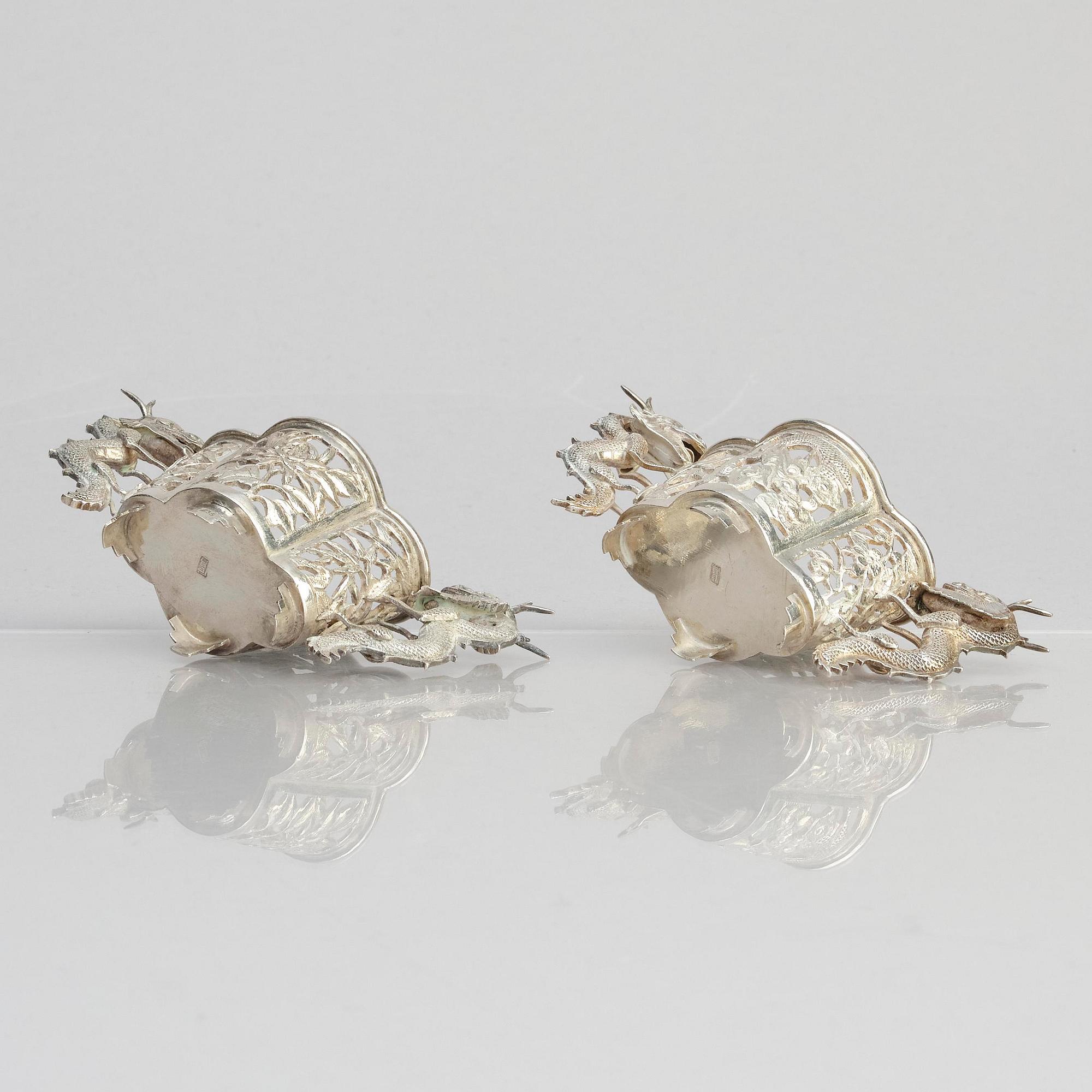A pair of  Chinese silver cup holders/salts, 20th century.