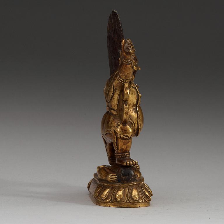 A Sinotibetan gilt bronze figure of a Dharmapala, Qing dynasty, 19th Century.