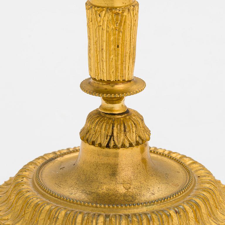 A pair of mid-19th-century gilded bronze candlesticks.