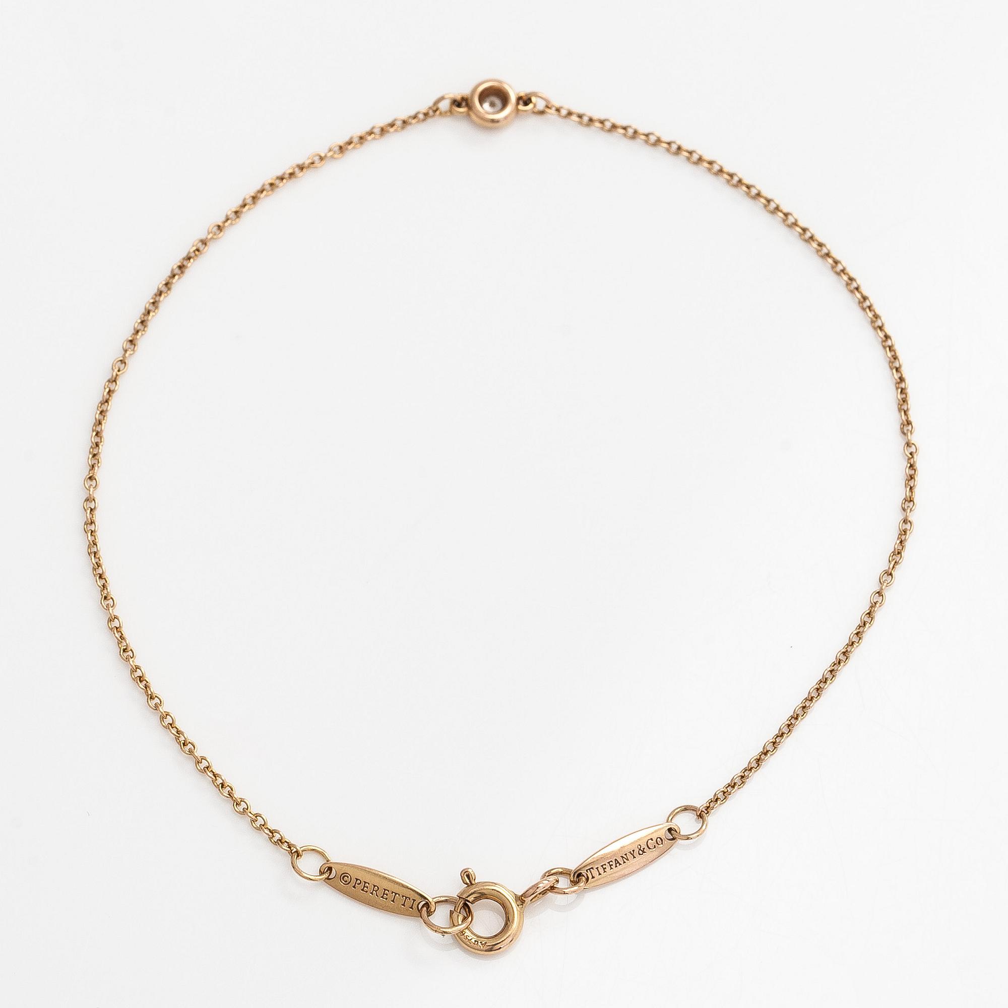 Tiffany & Co, an 18K gold 'Diamonds by the Yard' bracelet with a brilliant-cut diamond.