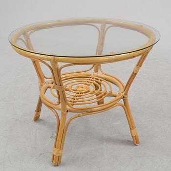 A 1970s four piece set of rattan garden furniture.