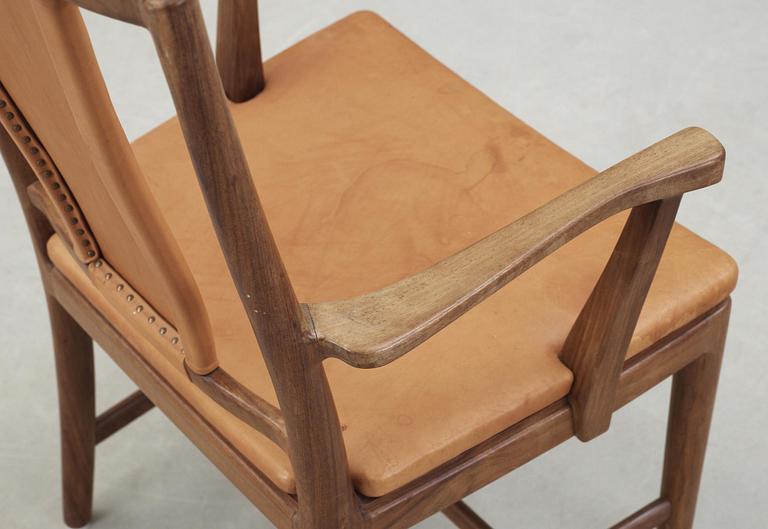 A Carl-Axel Acking walnut armchair, upholstered in light brown leather, Nordiska Kompaniet, Sweden, ca 1947.