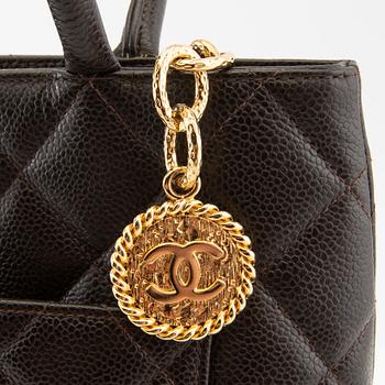Chanel, a "Medallion Tote" bag.